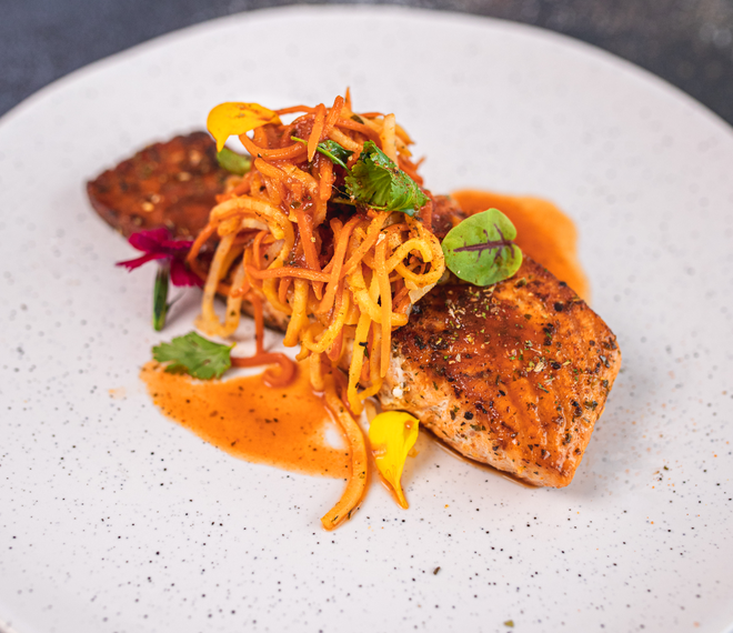 Pan seared salmon with carrot, celeriac julienne and hot sauce